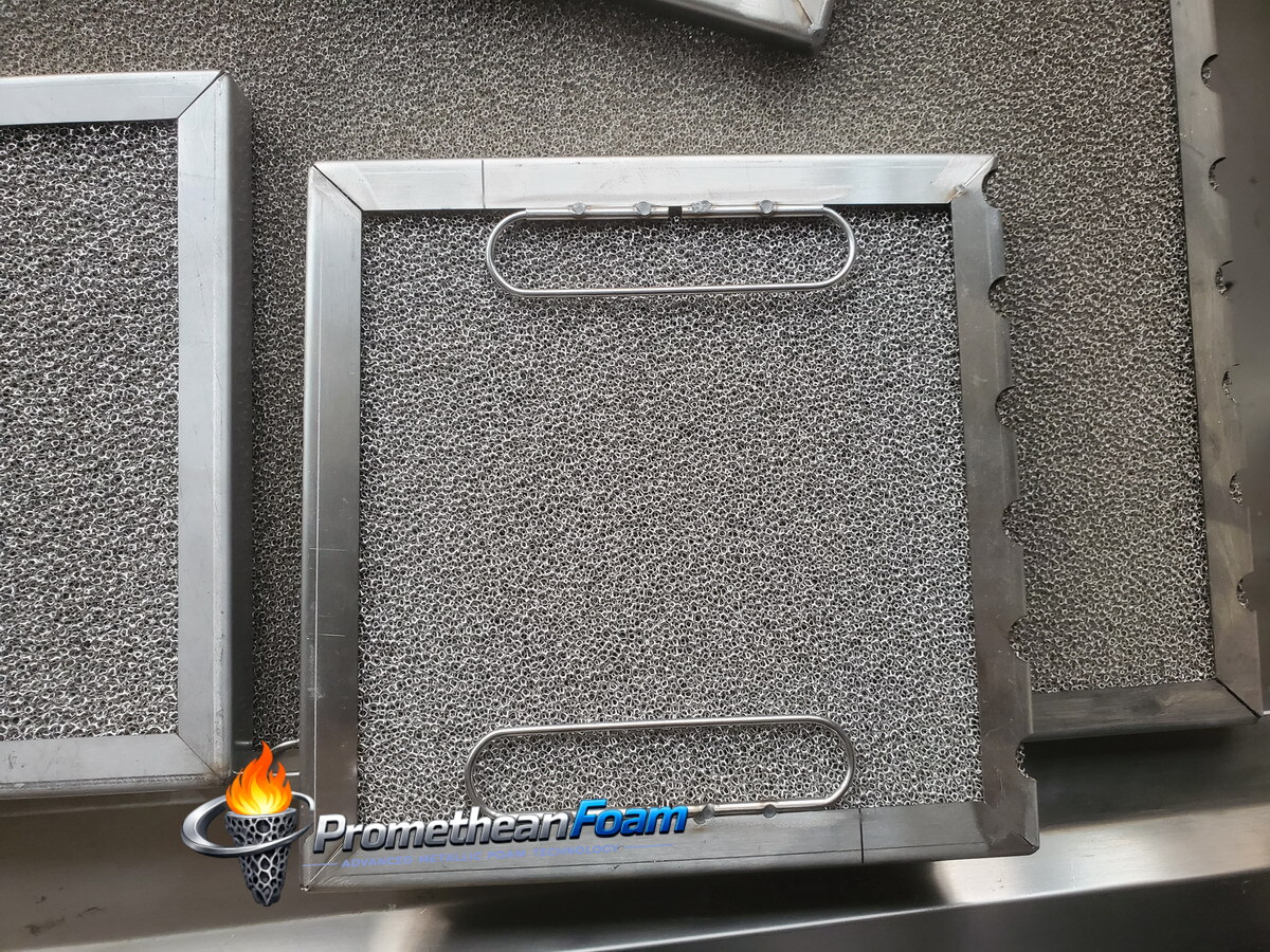 Close-up of foam metal grease filter 18/20 PPI open-cell structure — 3D depth filtration captures 98% grease particles vs 85-94% traditional baffle filters